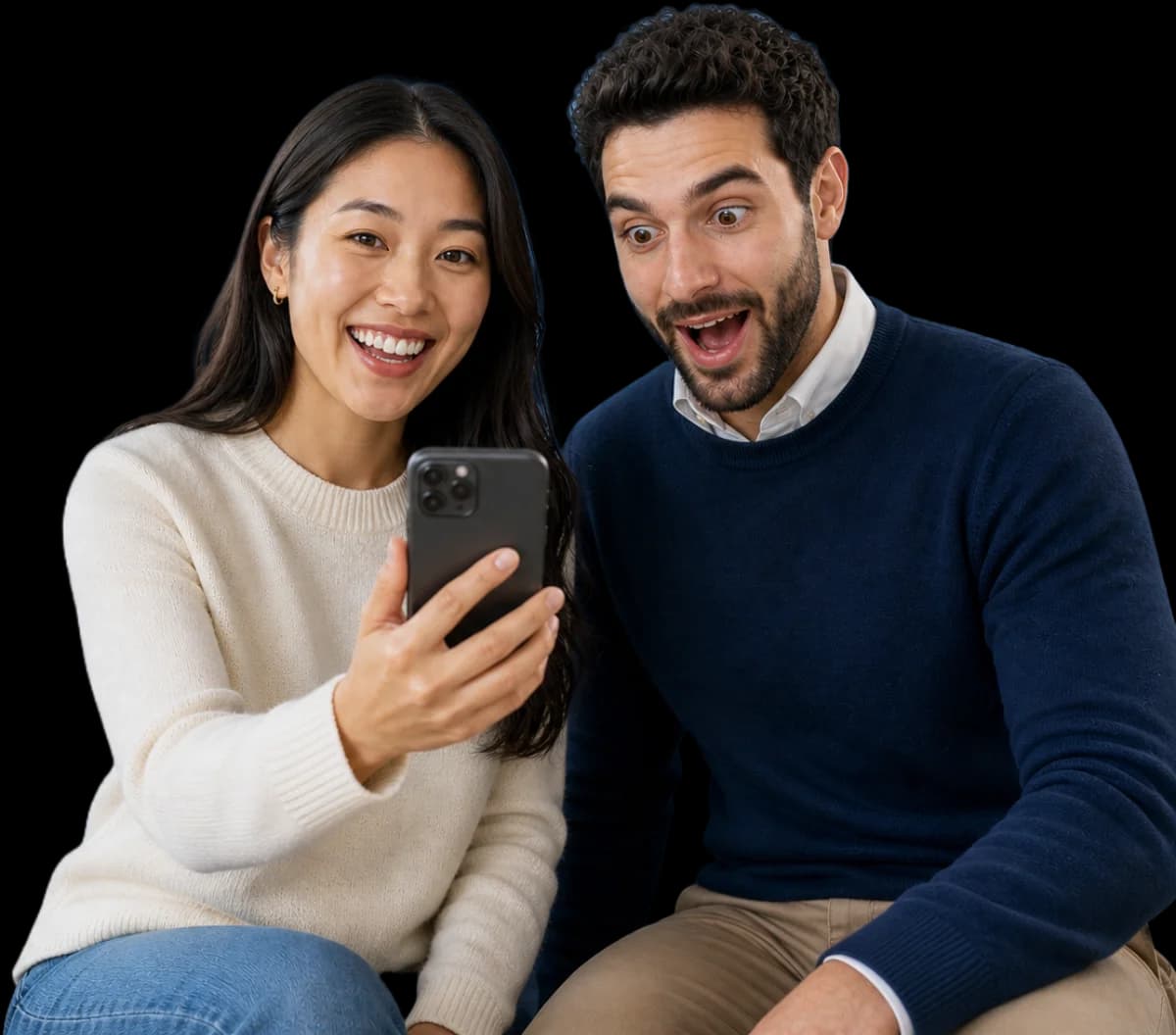 Two smiling students looking at a phone together
